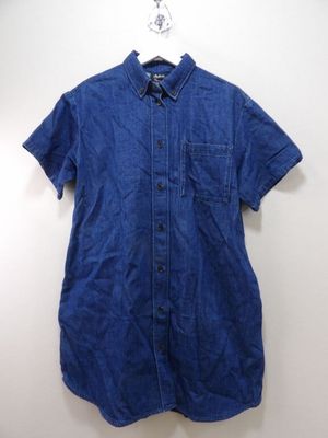 a blue shirt hanging on a hanger on a wall