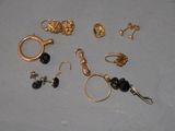 a lot of gold and black jewelry on a table