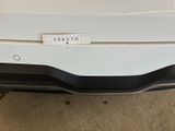 a picture of a white car with a sticker on it ' s bumper