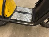 a scooter that is parked in a parking lot