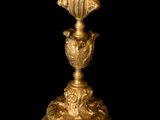 a gold vase on a black background with a black background