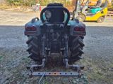 a tractor that is parked in the dirt