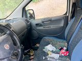 the interior of a car with blue seats and a black steering wheel