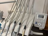 dental equipment sitting on a table in a room with white walls
