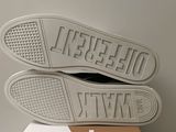 the soles of a pair of white sneakers on top of a box