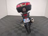 a motorcycle that is parked in a room with a checkered floor