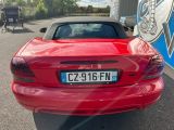 a picture of a red sports car parked in a parking lot