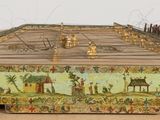 a wooden box with a painting on it sitting on a table
