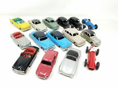 a lot of toy cars that are on a white surface