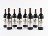 six bottles of red wine lined up in a row
