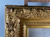 a picture of a gold framed mirror on the wall