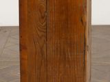 a small wooden cabinet on a parquet floor
