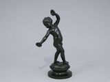 statue of a boy with a tennis racket in his hand