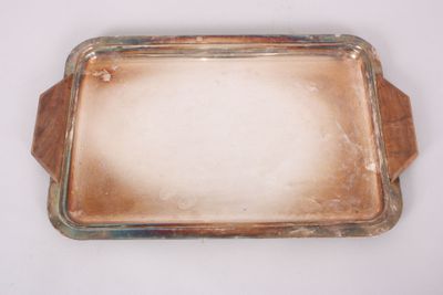 an old silver tray with a glass lid on a white surface