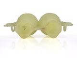pair of green plastic eyeglasses on white surface with reflection