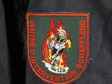 a close up of a firefighter ' s jacket with a fireman on it