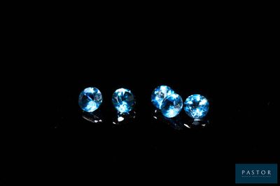 three blue diamonds in the dark on a black background