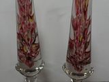 two glass vases that are sitting on a table