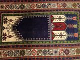 a close up of a rug on a wooden floor