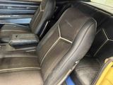 a picture of the inside of a car with black leather seats