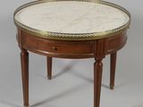a round marble top coffee table with two drawers