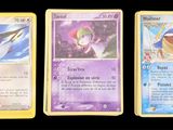 three pokemon cards are shown in a row on a black background