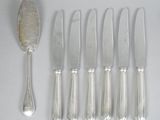 six silver spoons and six silver spoons on a table
