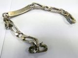 silver plated bracelet with a heart charm attached to it ' s link