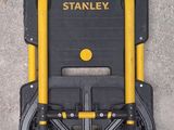 a black and yellow tool cart with two yellow handles
