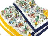 three napkins with a yellow border and a white and blue border