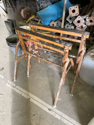 a bench made out of metal and wood in a garage