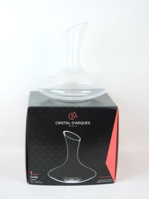 a clear glass vase sitting on top of a black box