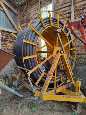 a large yellow hose on a cart in a building