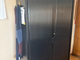a black metal cabinet in the corner of a room