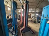 two machines that are sitting in a warehouse