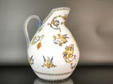 a white vase with a blue and yellow design on it