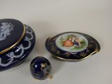 a small blue box with a picture of a woman on it next to a small blue egg
