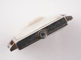 a close up of a watch on a white surface