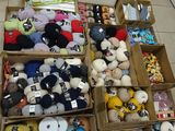 several boxes of stuffed animals are lined up on the floor