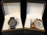 two watches that are in a box on a table