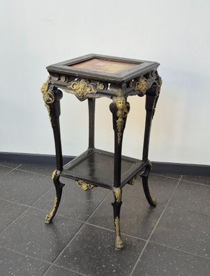 a small table with a marble top on a tiled floor