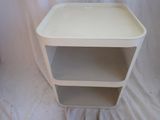 a small white table with two shelves on it