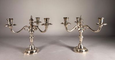 pair of silver plated candelabs with angels on each of them