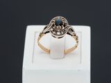 Gros plan sur une bague en or ornée d'une pierre bleue