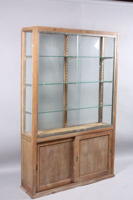 a display case with glass shelves and a wooden base