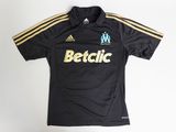 a black shirt with a yellow stripe on the chest and a white shirt with a yellow stripe on the chest