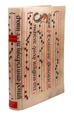 an old book with red and black writing on a white background