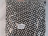 a black and white pillow in a plastic bag