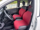 two red seats in the back of a small car