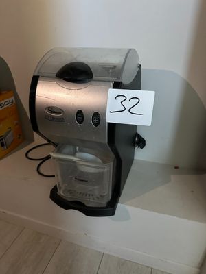 a coffee maker sitting on a shelf with a price tag attached to it